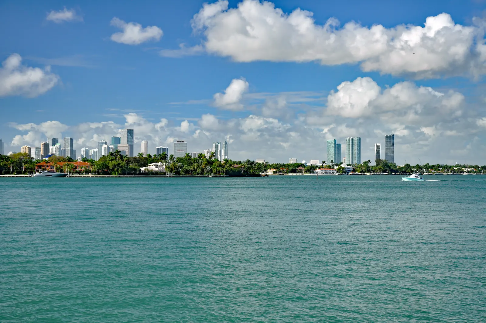Water, palm-lined islands and the Miami skyline beneath white clouds.